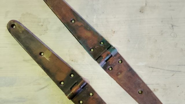 image of a pair of large bronze hinges