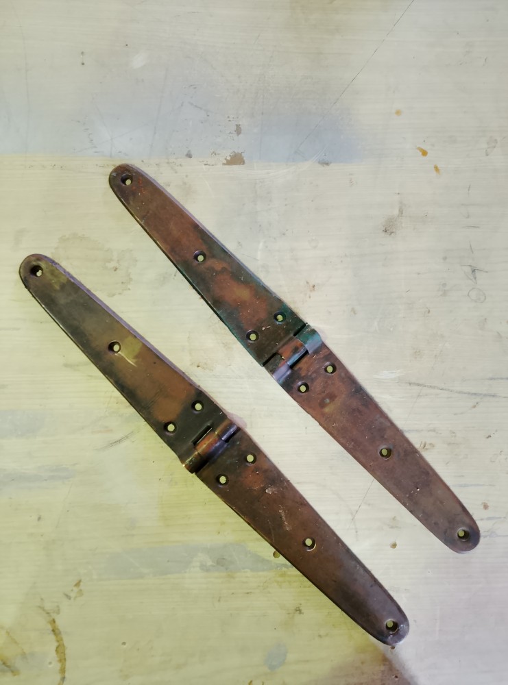 image of a pair of large bronze hinges